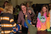 students and adults at activity station