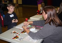 student and adult at activity station