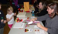 students and adults at activity station