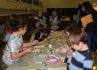 students and adults at activity station