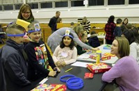 students and adult playing head bandz game