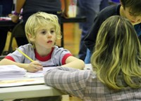 adult and student at activity station