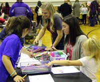 students and adults at activity station