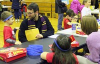 students and adults at activity station