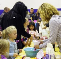 students and adults taking part in activity 