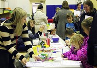 students and adults at activity station