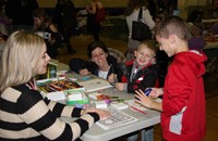 students and adults at activity station