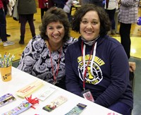 two educators smiling