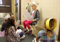 student reading to peers