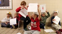 students holding up book covers