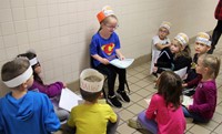 student reading to peers