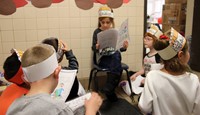 student reading to peers