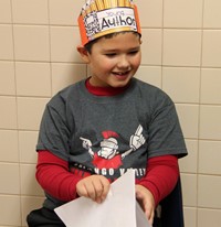 student smiling with book