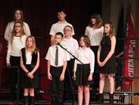 sixth grade chorus members singing