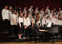 medium shot of seventh and eighth grade chorus members singing