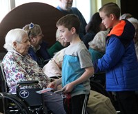 student handing resident ornament