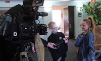 students speaking with reporter