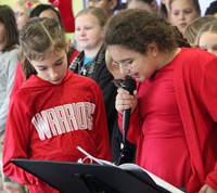 medium shot of students singing