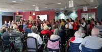 wide shot of chorus members performing