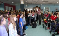 students performing for elizabeth church manor residents