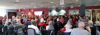 wide shot of students singing for elizabeth church manor residents