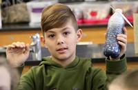 student holding up mindfulness jar