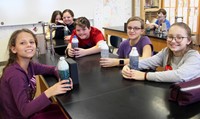 students smiling holding mindfulness jars 