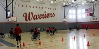 wide shot of students taking part in adaptive sports in gymnasium