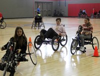 medium shot of students taking part in adaptive sports in gymnasium