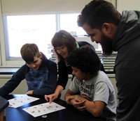 students and teacher taking part in financial wellness activity