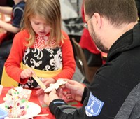 two people making gingerbread house