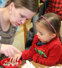 two people working on gingerbread house