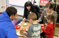 people creating gingerbread houses