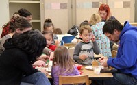 families working on gingerbread houses