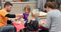 people working on gingerbread houses