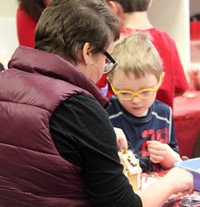 two people making gingerbread house