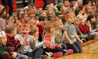 students sitting wearing reindeer hats