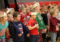 students standing wearing reindeer hats