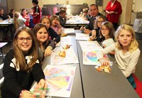 students at table with superintendent