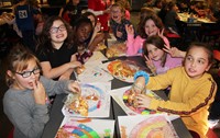 students holding up friendship bracelets