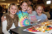 students at table during friendship feast