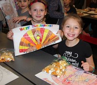 four students smiling at friendship feast