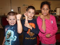 students smiling at table during friendship feast