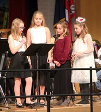 four students introducing song