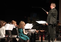 band instructor leading students in concert