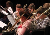 students playing band instruments in concert
