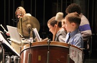 students playing percussion instruments in concert