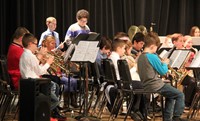 students playing band instruments in concert