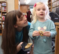 two people holding monster cookies