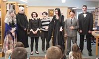 medium shot of theatre guild members speaking in front of library guests